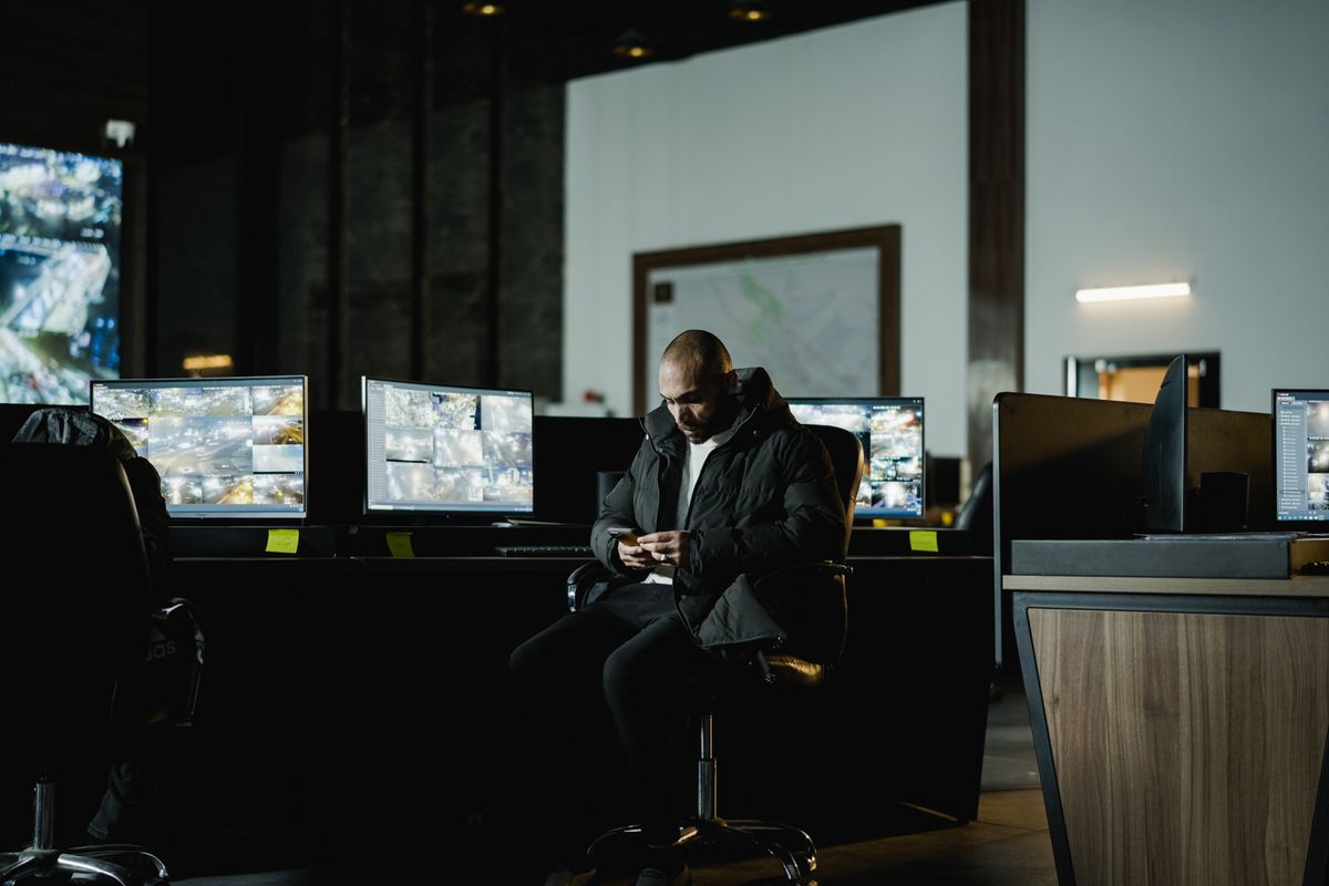 Operator bewaakt camerabeelden in een 24/7 meldkamer
